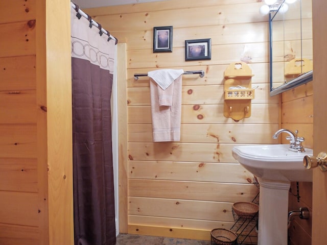 bathroom featuring wood walls