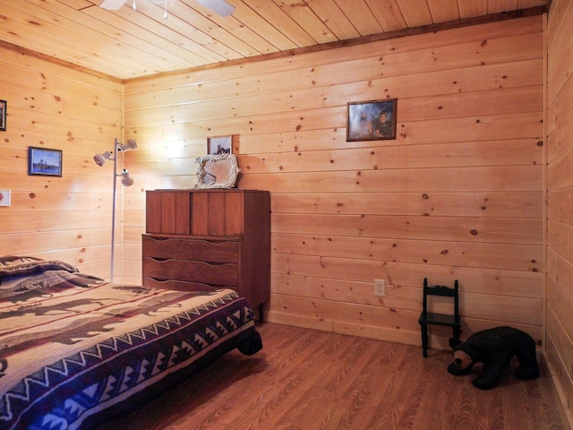 bedroom featuring hardwood / wood-style floors, wood ceiling, and wood walls