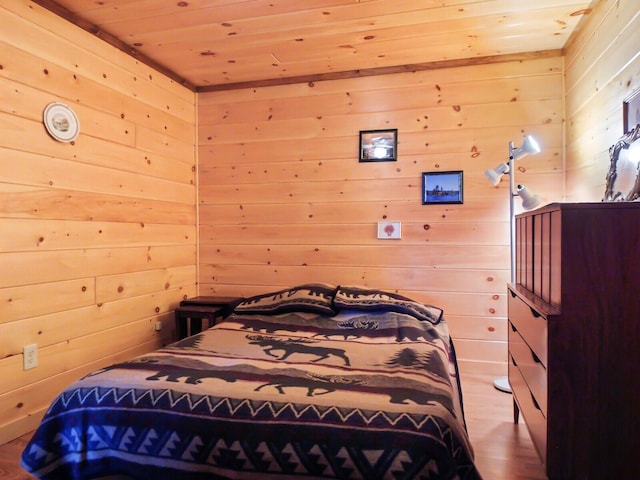 bedroom featuring wooden walls and wooden ceiling