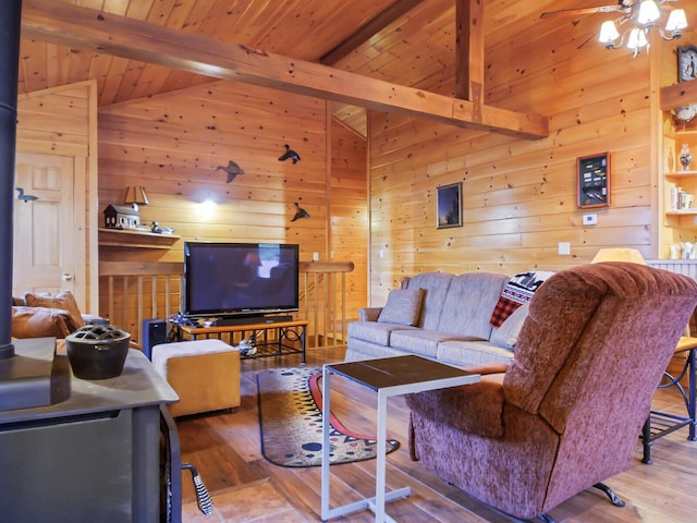 living room with hardwood / wood-style flooring, vaulted ceiling with beams, wooden ceiling, and wooden walls