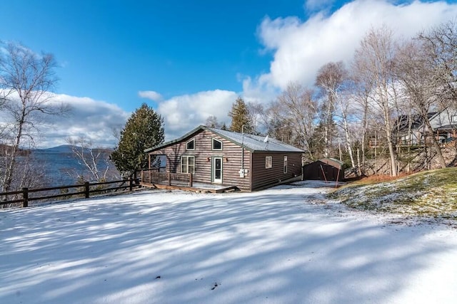 snow covered property with a deck with mountain view