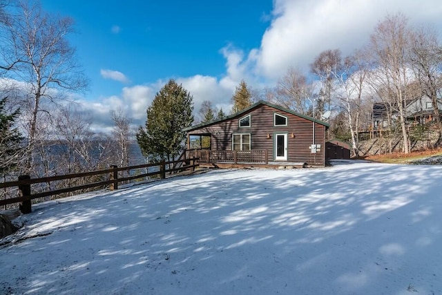 view of snow covered back of property