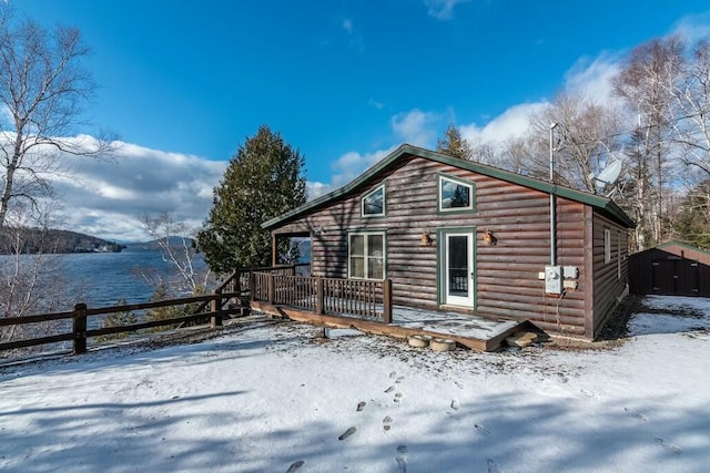 snow covered house with a deck