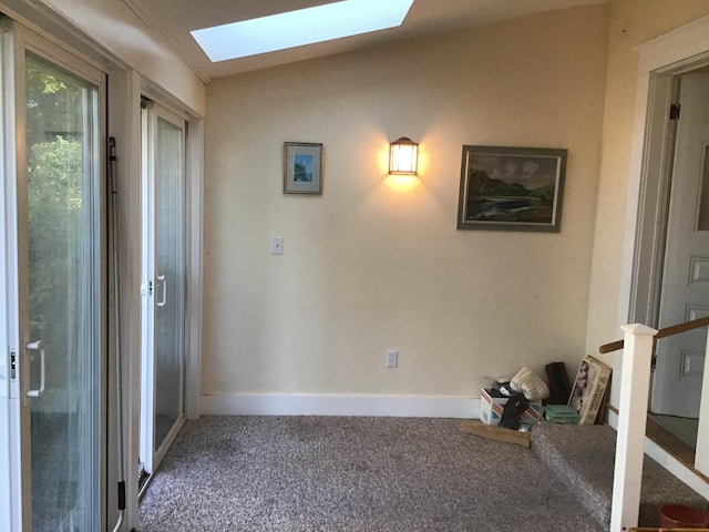 interior space with carpet floors and a skylight