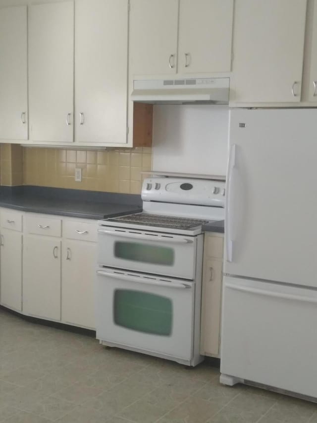 kitchen with tasteful backsplash, white appliances, and white cabinets