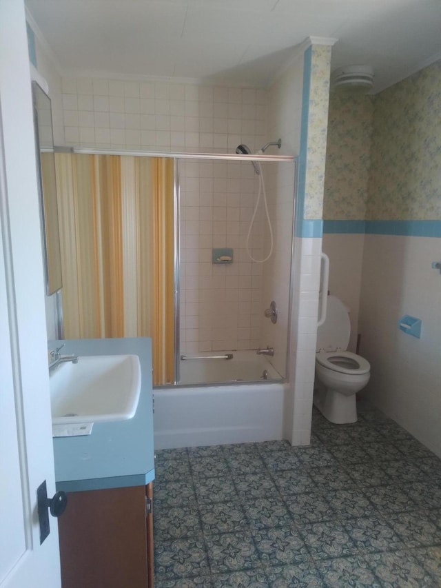 full bathroom featuring tile patterned flooring, tile walls, vanity, toilet, and tiled shower / bath