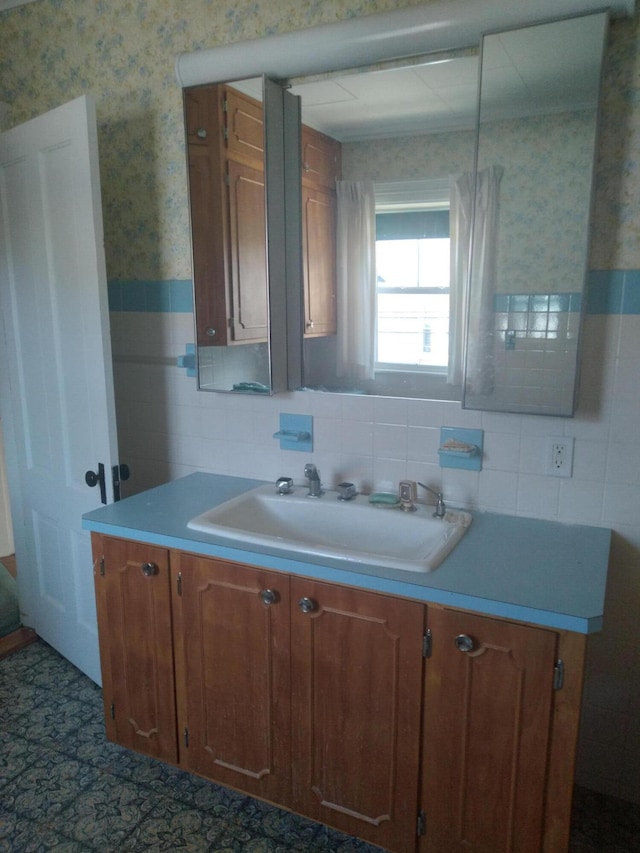 kitchen featuring sink and tile walls