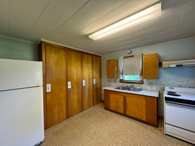 kitchen with light carpet, backsplash, white appliances, and sink