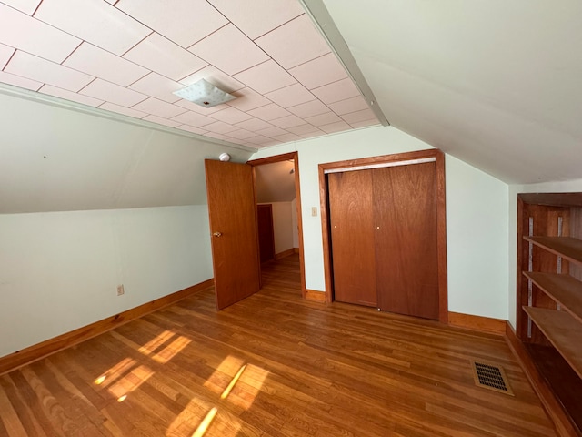 bonus room featuring vaulted ceiling and hardwood / wood-style floors