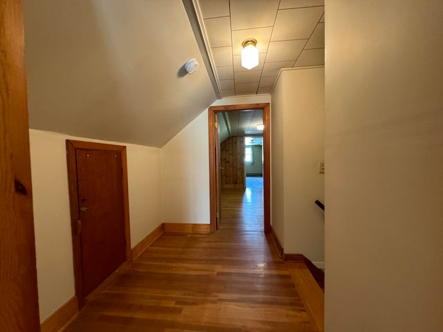 corridor featuring lofted ceiling and wood-type flooring