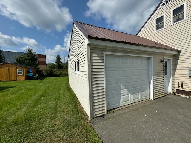 garage featuring a lawn