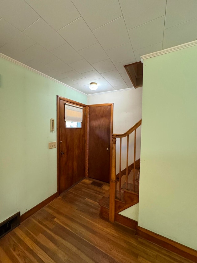 entrance foyer featuring dark hardwood / wood-style flooring and crown molding