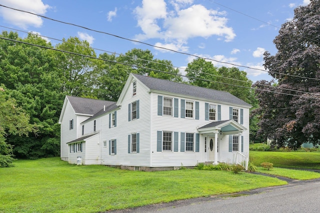 colonial inspired home with a front lawn