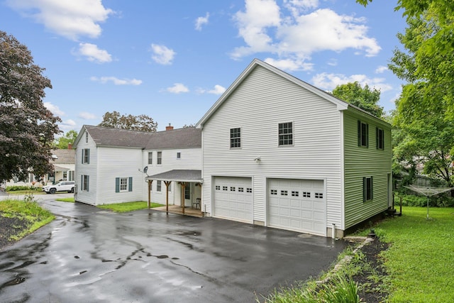 view of side of property with a garage and a yard