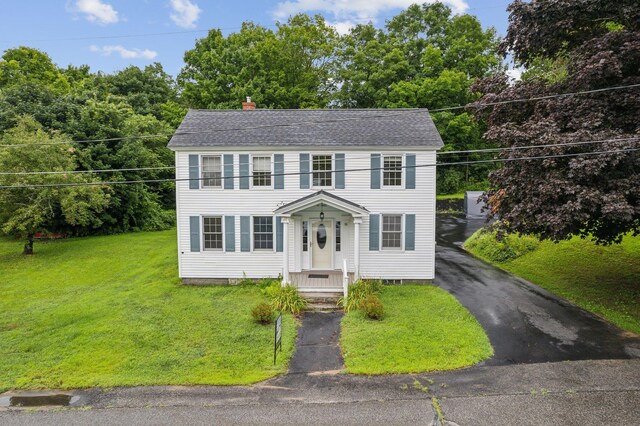 colonial home with a front lawn