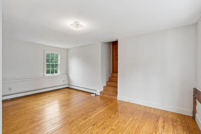 unfurnished room with light hardwood / wood-style floors and baseboard heating