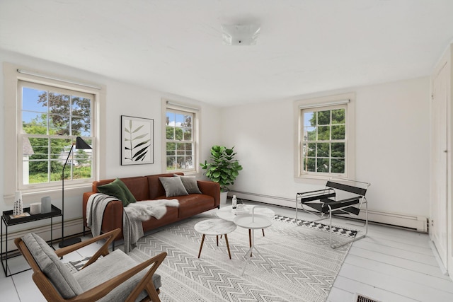 living room featuring light hardwood / wood-style flooring and a baseboard heating unit