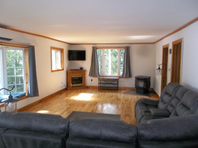 living room featuring a healthy amount of sunlight, ornamental molding, and hardwood / wood-style floors