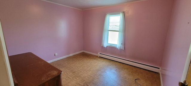 spare room with baseboard heating and light parquet floors