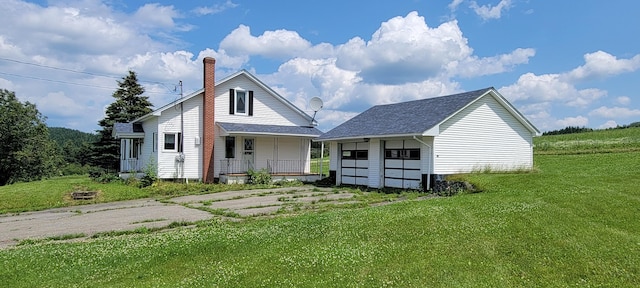 back of property with a porch and a lawn