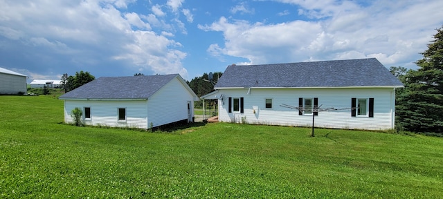 rear view of property featuring a yard