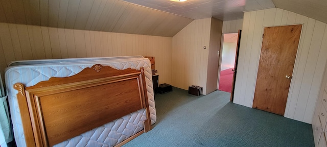 bedroom featuring carpet flooring, wood walls, and vaulted ceiling