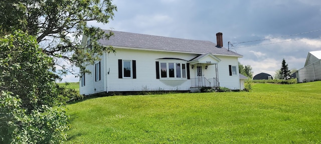 back of property featuring a yard