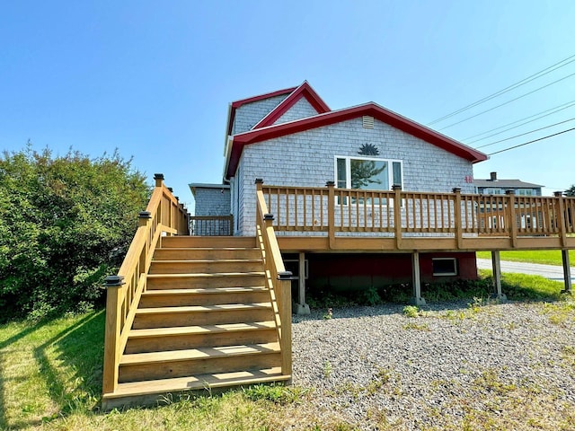 rear view of property featuring a wooden deck