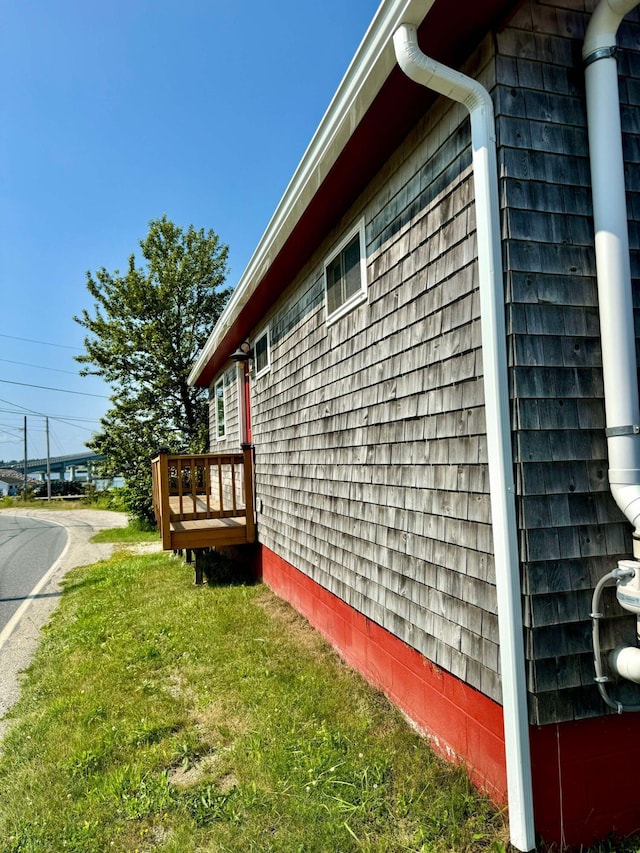 view of side of home featuring a lawn