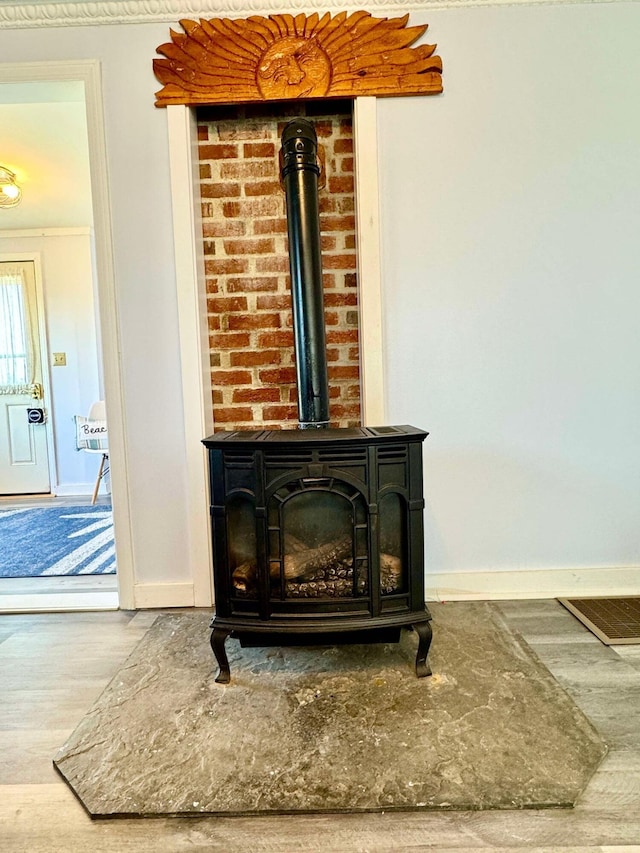 details featuring hardwood / wood-style flooring and a wood stove