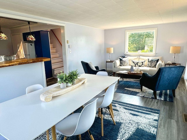 dining space featuring wood-type flooring