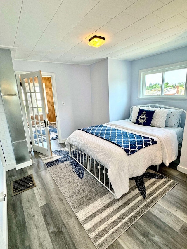 bedroom with wood-type flooring and french doors