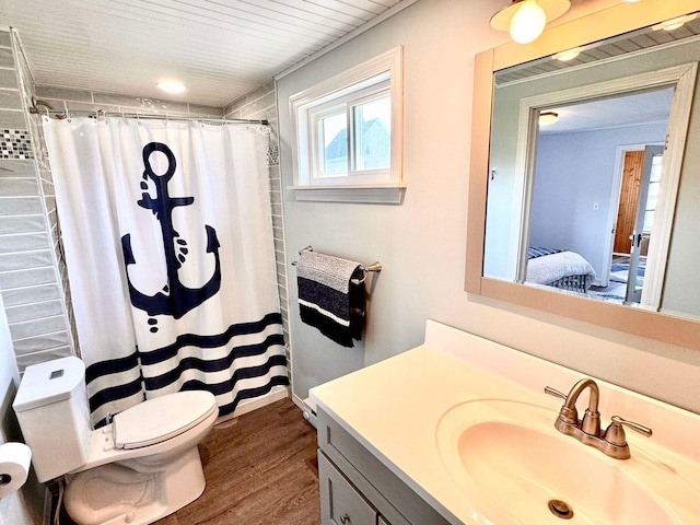 bathroom featuring vanity, wood-type flooring, toilet, and walk in shower