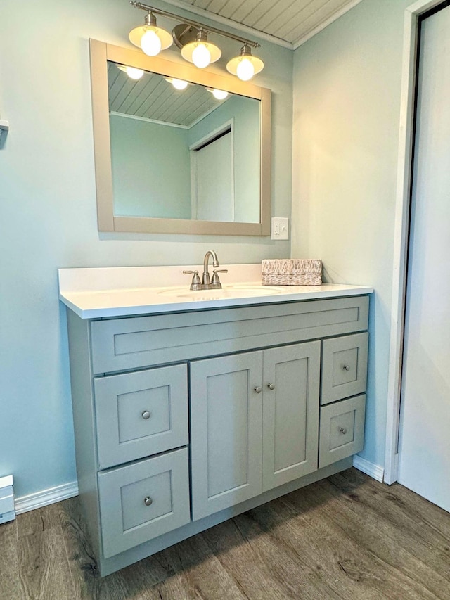 bathroom featuring vanity, hardwood / wood-style floors, and wood ceiling