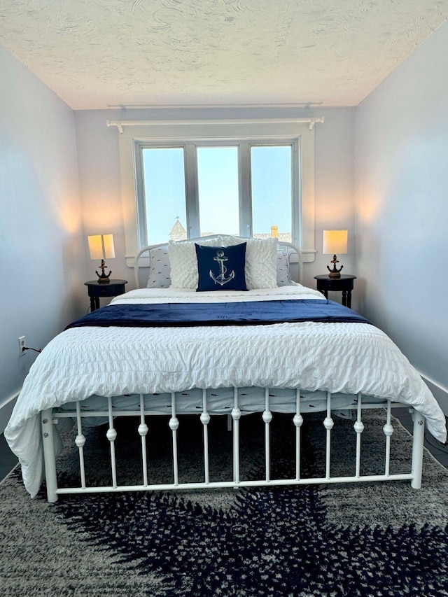 bedroom featuring multiple windows and a textured ceiling