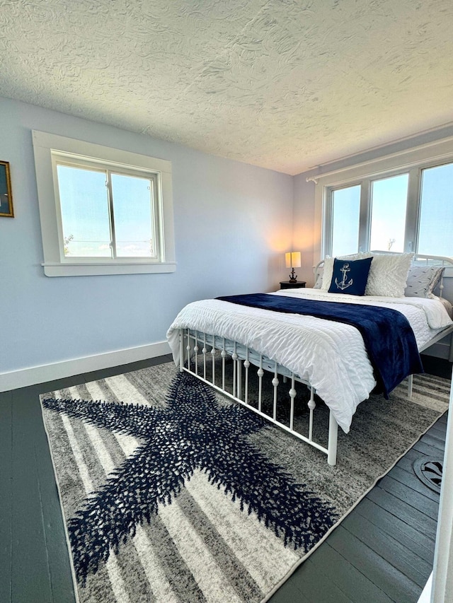 bedroom featuring wood-type flooring and a textured ceiling