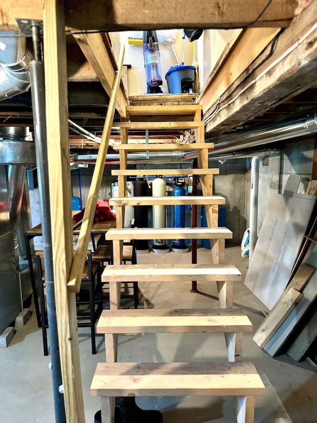 staircase featuring concrete floors