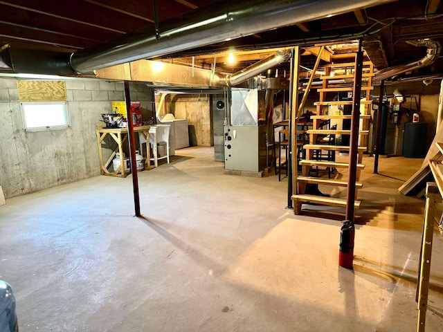 basement with heating unit and washing machine and dryer