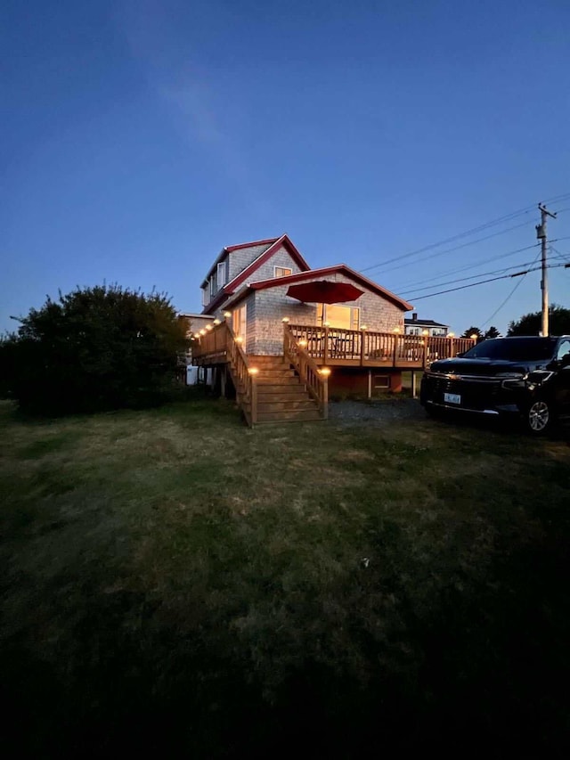 exterior space featuring a wooden deck and a yard