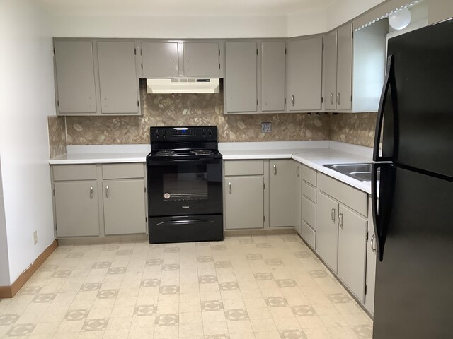 kitchen with black appliances, gray cabinets, and light tile patterned floors