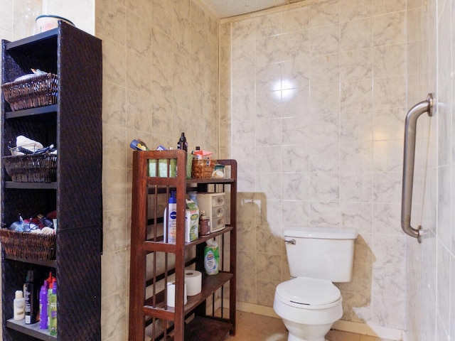 bathroom featuring a shower, tile patterned flooring, tile walls, and toilet