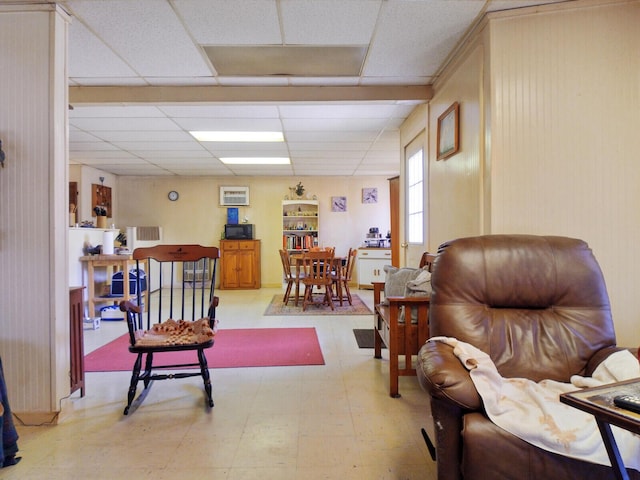 living room featuring a paneled ceiling