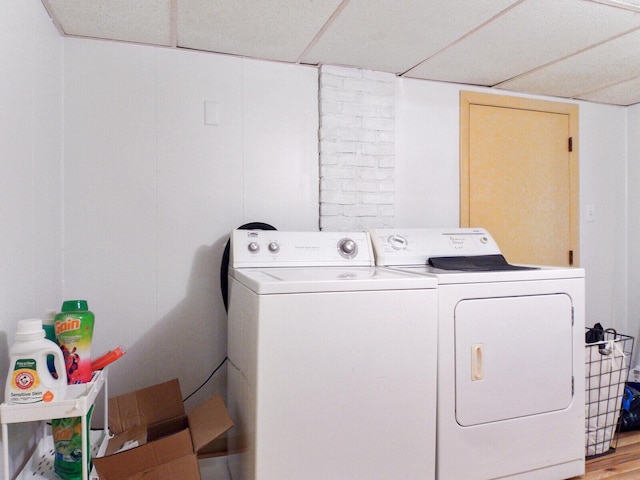 washroom featuring washing machine and clothes dryer and hardwood / wood-style floors