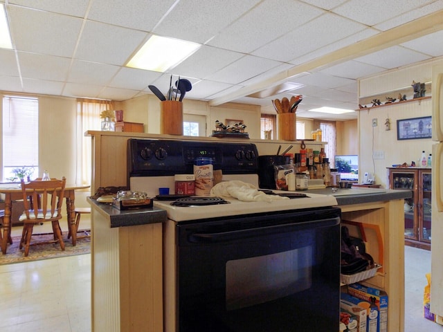 kitchen featuring white range with electric cooktop and a paneled ceiling