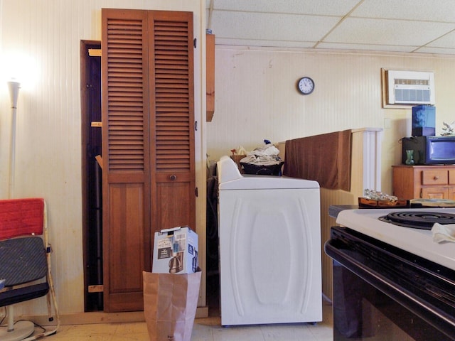 washroom featuring washer / dryer, a wall mounted AC, and wood walls