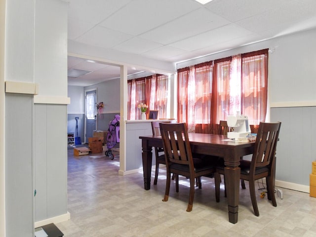 dining area featuring a drop ceiling