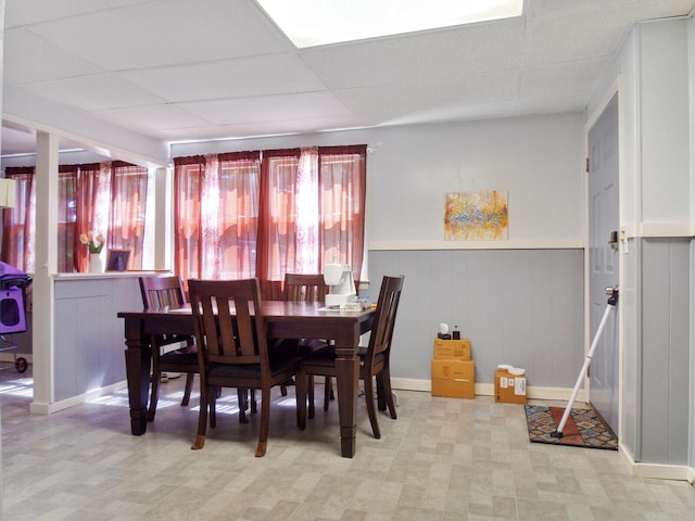 dining room featuring a drop ceiling