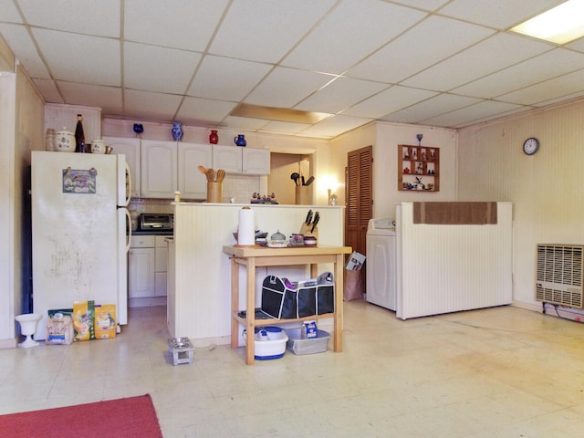 kitchen with white cabinets, white fridge, and washer / clothes dryer