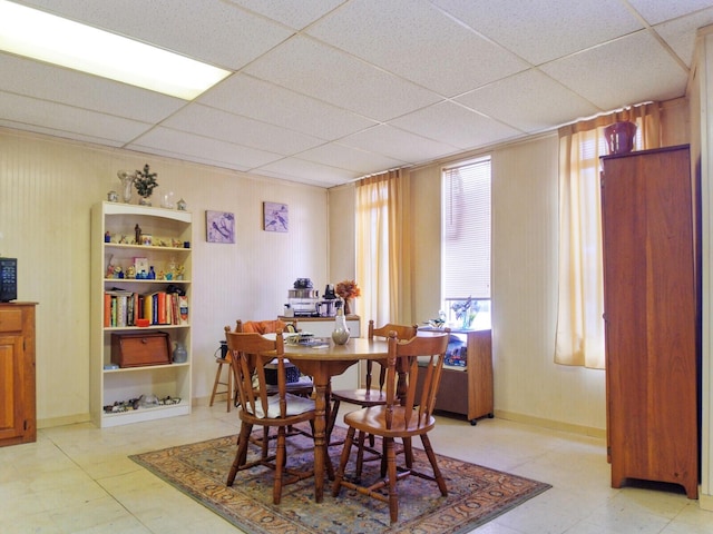 dining area featuring a paneled ceiling