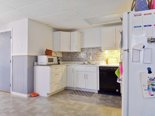 kitchen featuring decorative backsplash, white cabinetry, white appliances, and sink